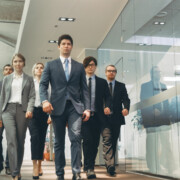 Diverse Team of Delegates/ Lawyers Confidently Marching Through the Corporate Building Hallway. Multicultural Crowd Of Resolute Business People in Stylish Marble and Glass Offices.