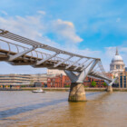 London, UK - May 23 2018: View of St Paul's Cathedral with people crossing the Millenium Bridge (London Millennium Footbridge)