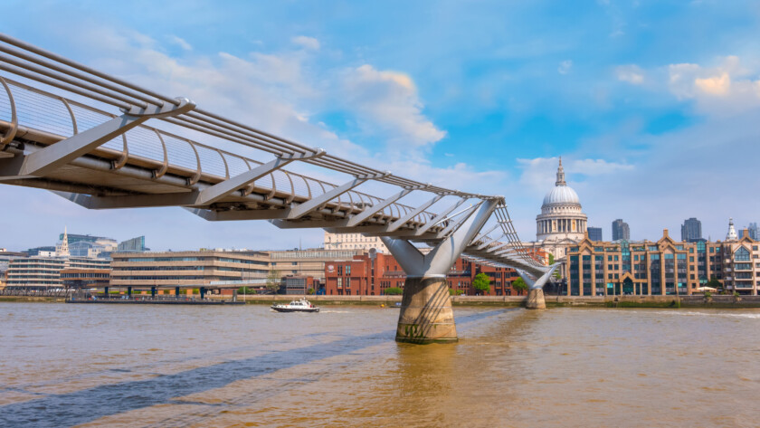 London, UK - May 23 2018: View of St Paul's Cathedral with people crossing the Millenium Bridge (London Millennium Footbridge)