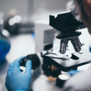 Young scientist looking through a microscope in a laboratory. Young scientist doing some research.