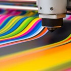 Vibrant abstract colorful paint patterns created by industrial machine.
