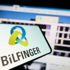 Stuttgart, Germany - 09-14-2023: Mobile phone with logo of German construction company Bilfinger SE on screen in front of website. Focus on center-right of phone display.