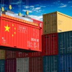 Freight shipping container with flag of China on crane hook - 3D illustration