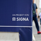 Munich, Germany - 06 23 2023 - Sign of the insolvent real estate company Signa on the construction site of the Karstadt building in Munich.
