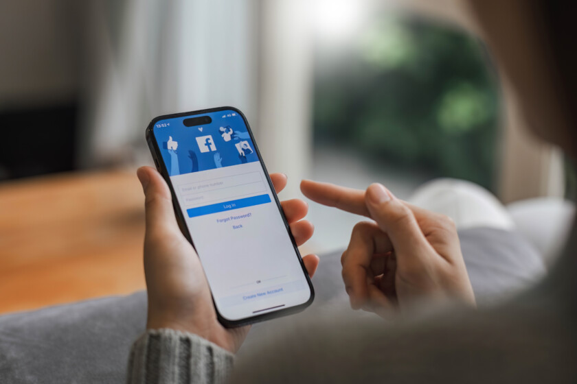 CHIANG MAI, THAILAND - APR 16, 2023: Facebook social media app logo on log-in, sign-up registration page on mobile app screen on iPhone 14 in person's hand working on e-commerce shopping business