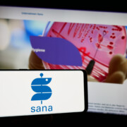 Stuttgart, Germany - 12-31-2023: Person holding smartphone with logo of German healthcare company Sana Kliniken AG in front of website. Focus on phone display.